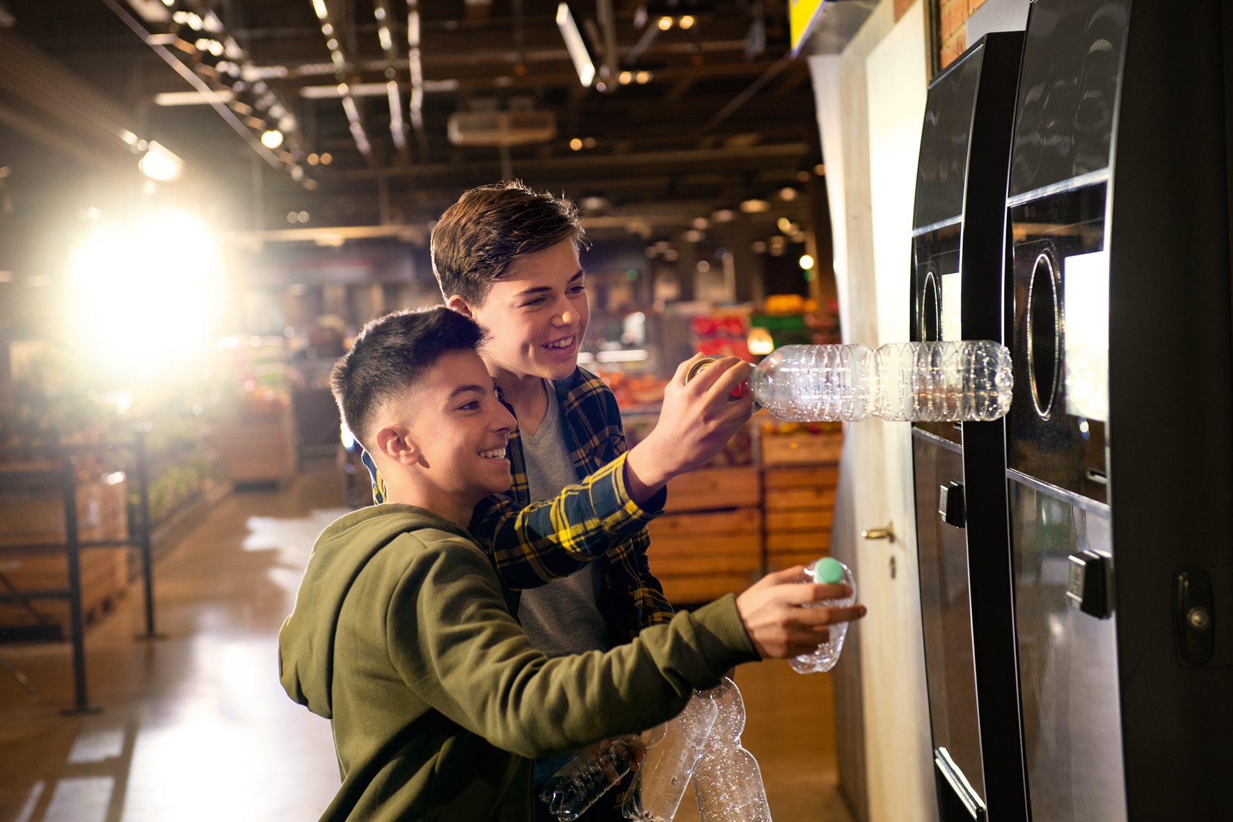 Boys using reverse vending machines